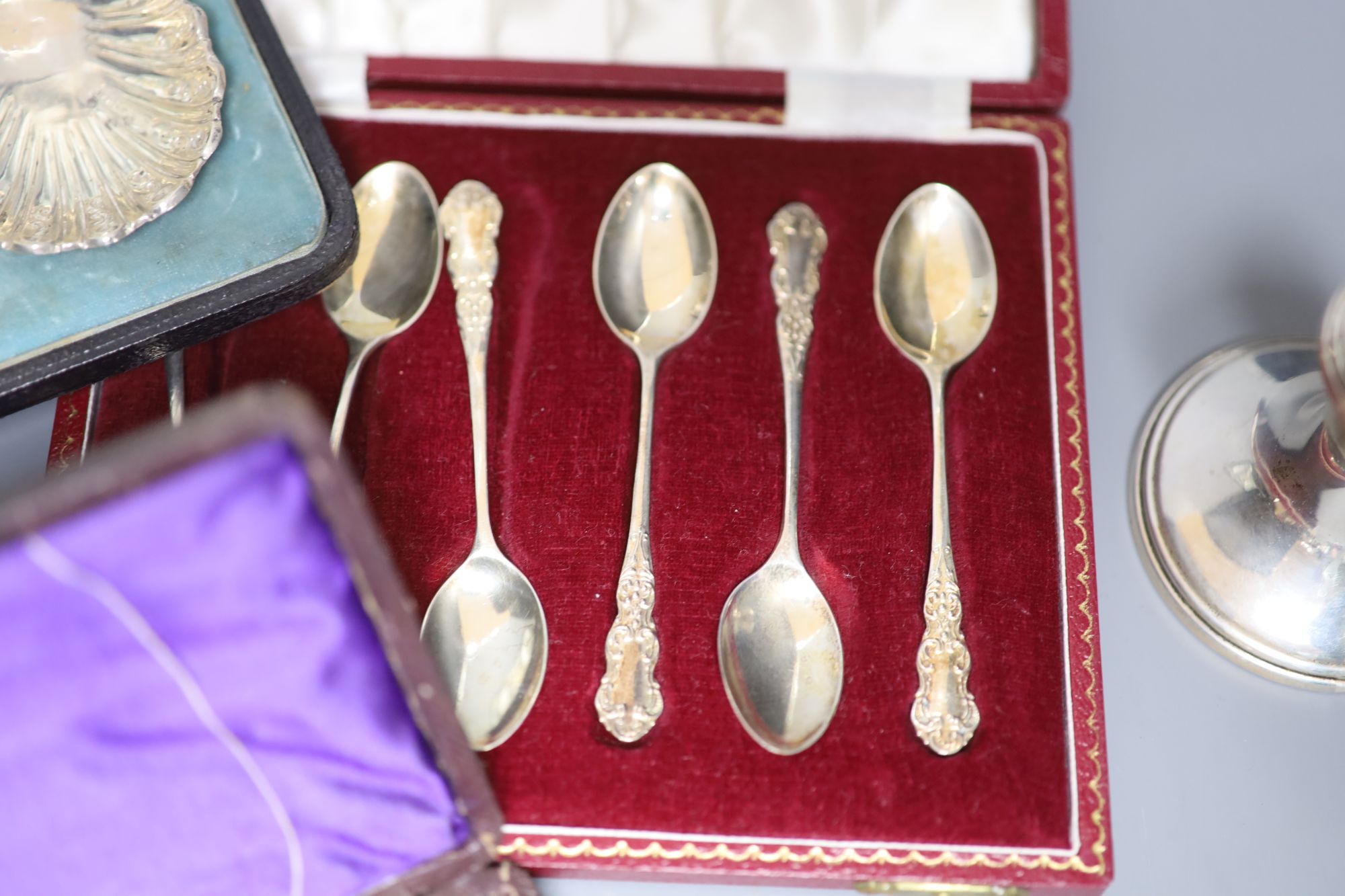 A pair of silver dwarf candlesticks and various cased silver items,